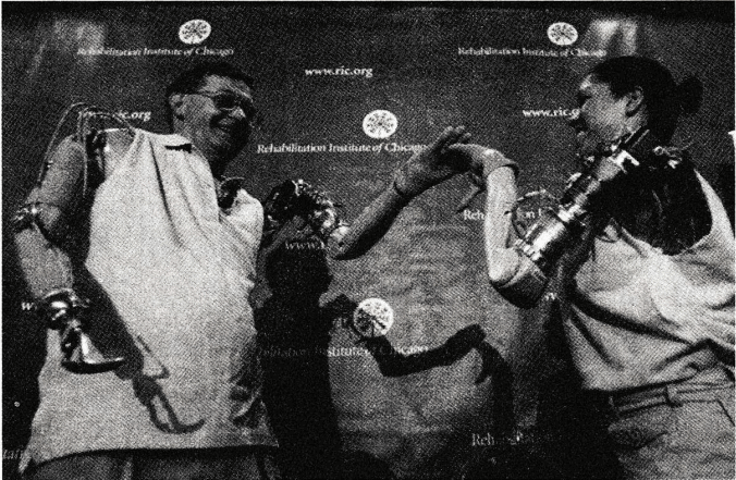 图28 杰西·沙利文和克劳迪亚·米切尔握手。他们的生化手臂只要用意识就能操纵，十分令人惊奇。